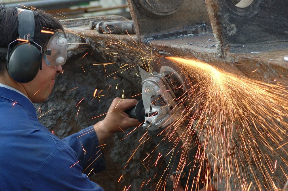 Tradie using tool with sparks flying