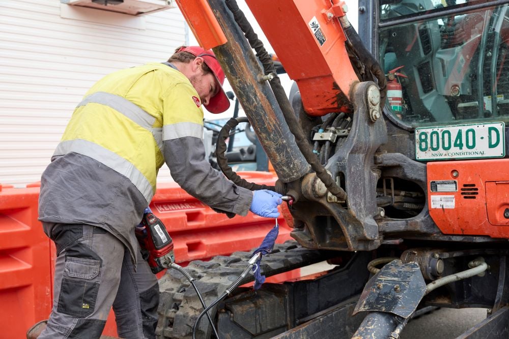 Kennards Hire team member working on a piece of equipment