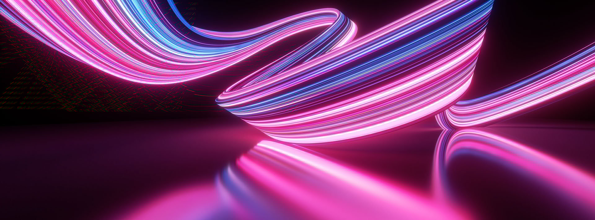 Abstract swirl of pink and blue lights on a black background