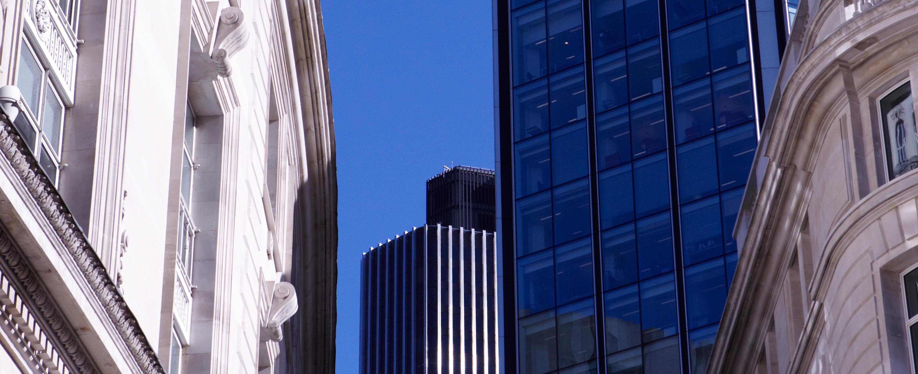Exterior vista of a mixture of traditional and modern buildings with a blue sky in the background