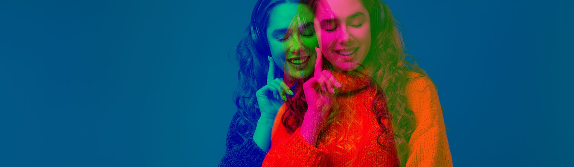 Lewis Silkin Person wearing headphones & smiling, double exposed in magenta and green on a navy background
