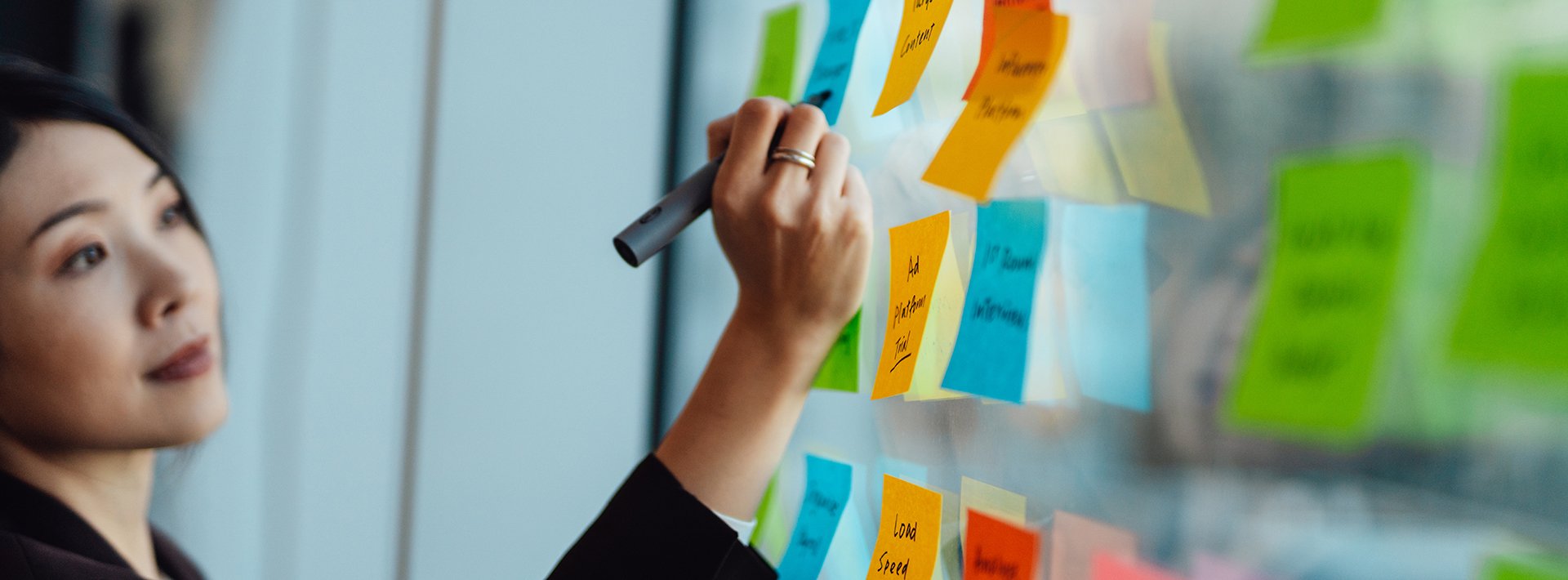 Lewis Silkin person-writing-on-sticky-notes_employment-litigation-business-process_2024_banner