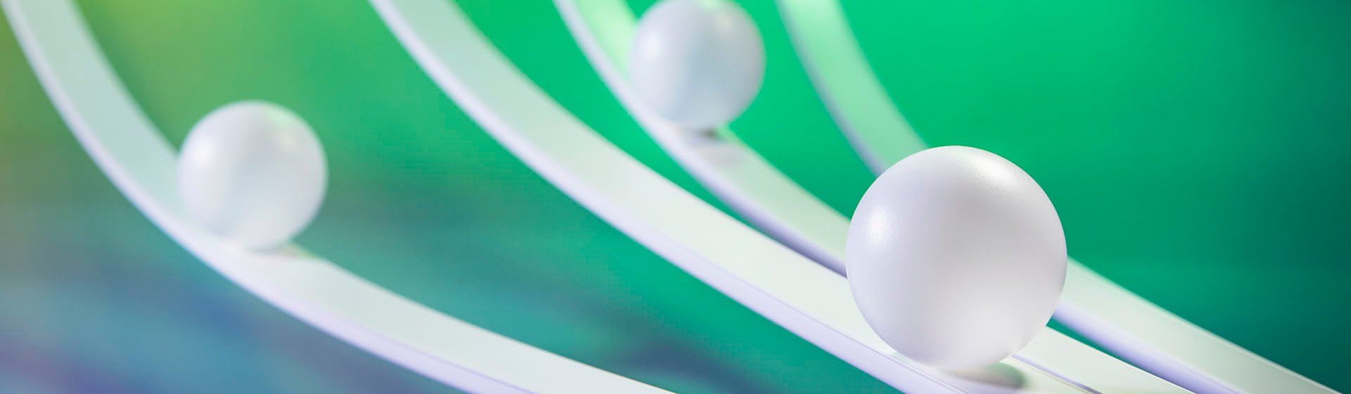 Lewis Silkin Three white balls sit on curved white surfaces, behind is a green background with blue shadows