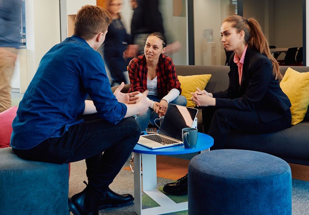 Lewis Silkin People gathered in an open area of an office meeting