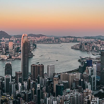 Sunset view from the peak in Hong Kong showing the Central district and Kowloon across the harbour with hills in the distance