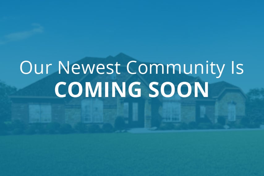 Our Newest Community is Coming Soon text over out-of-focus home image.