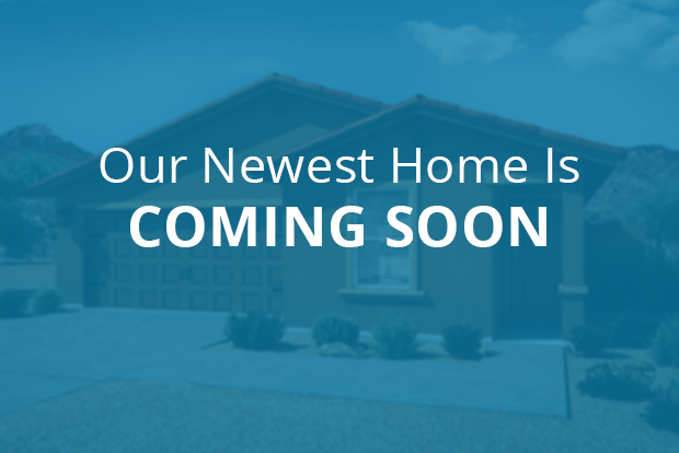 Text reading "Our Newest Home is Coming Soon" overlaid on blurred out home image