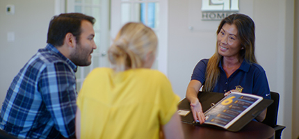 Couple sitting with New Home Consultant