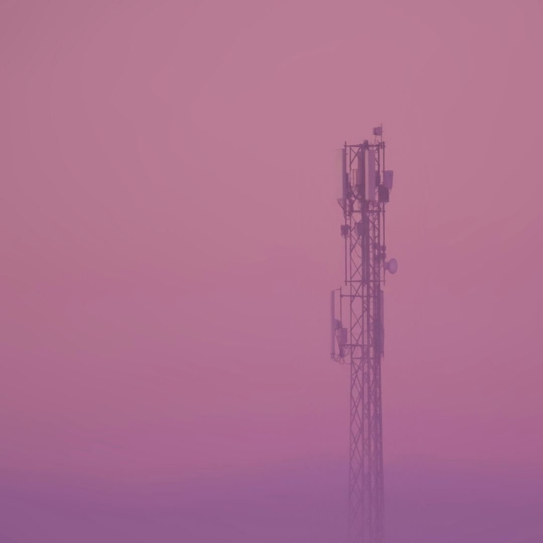 communication tower against magenta sky