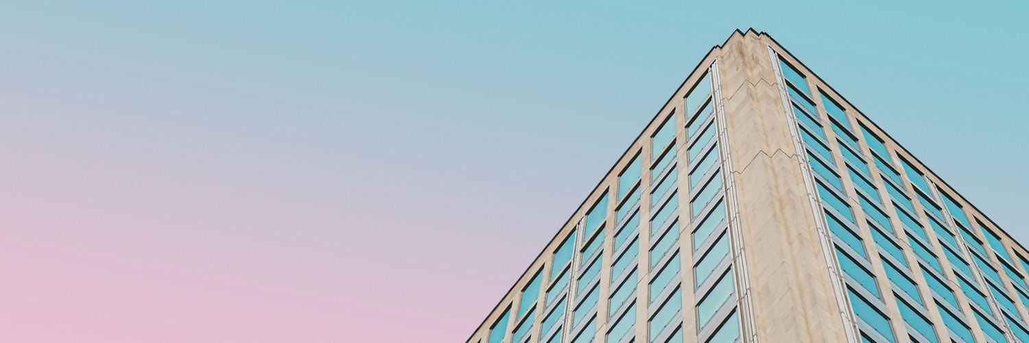 corner of flats against a multicoloured sky