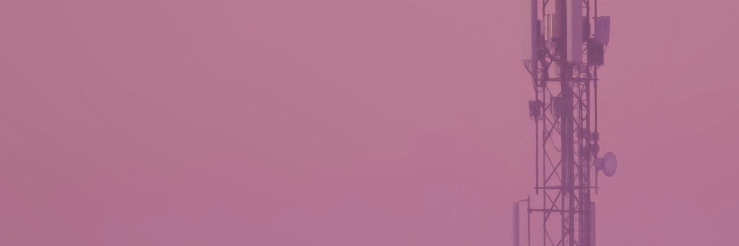 communication tower against magenta sky