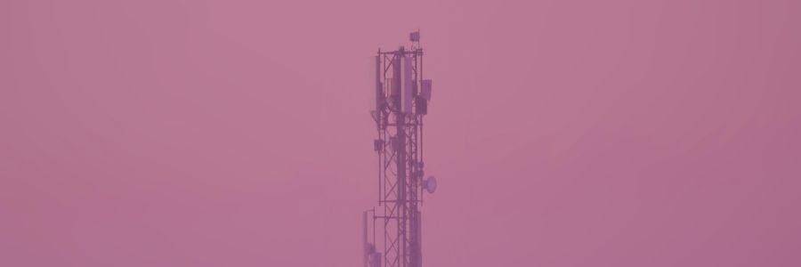 communication tower against magenta sky