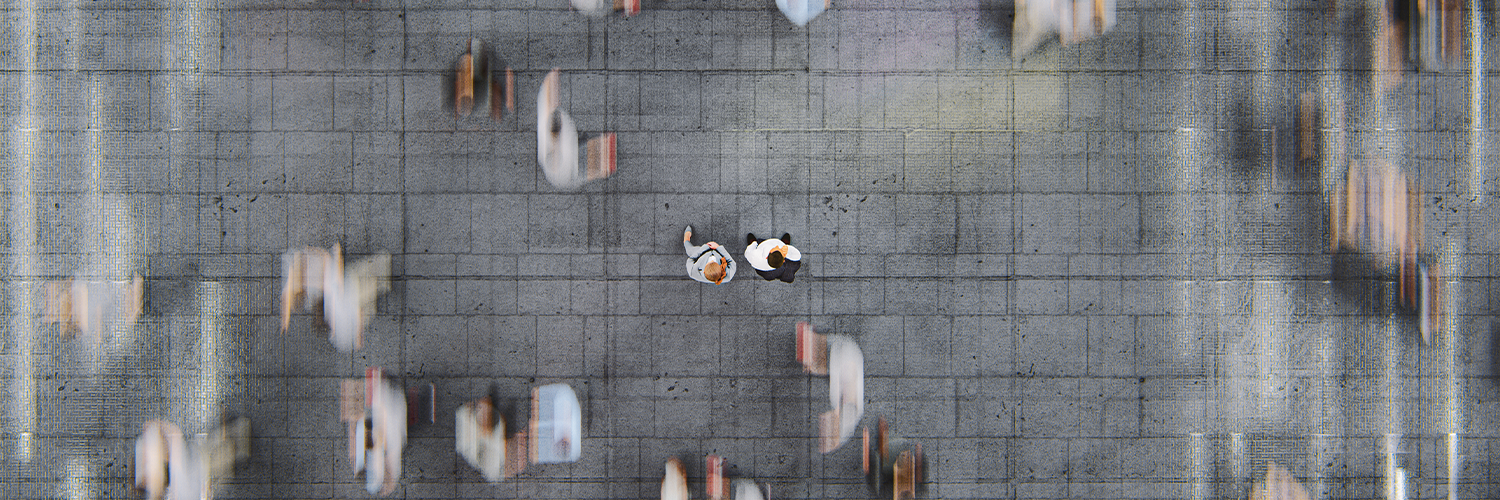 Businessman standing in the fast moving crowds of commuters