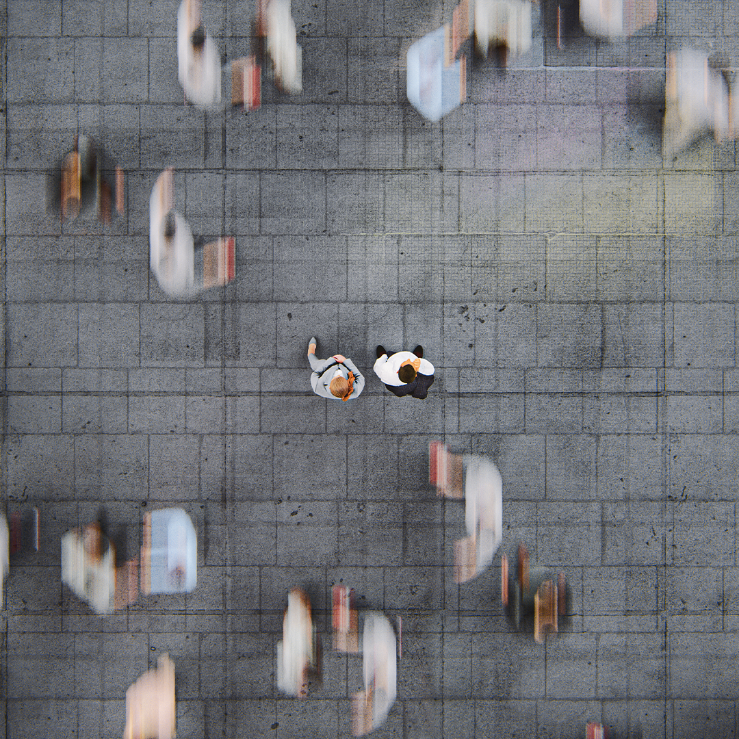 Businessman standing in the fast moving crowds of commuters