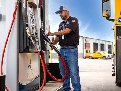 Man pumping diesel at a Trillium pump