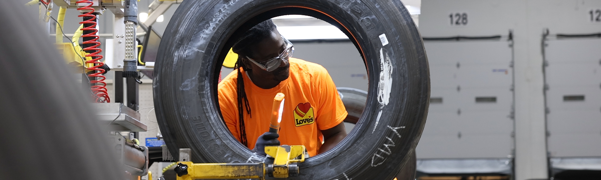 Retread employee working on a retread tire.