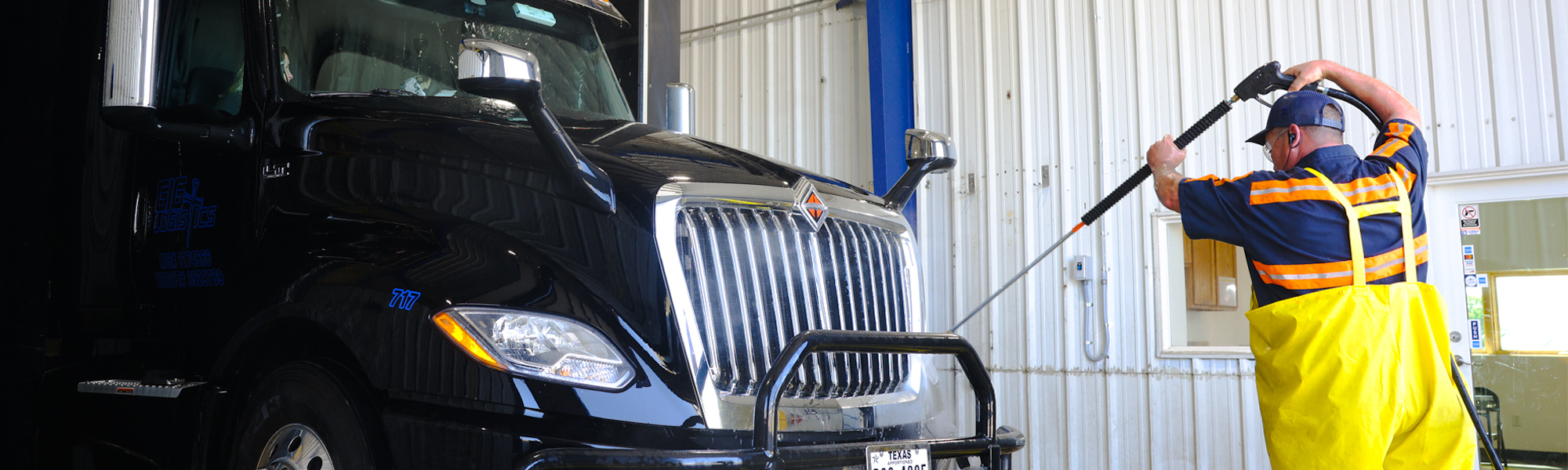 A photo of a Love's Truck Wash technician washing a commercial truck.