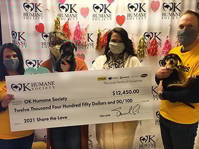 loves employees present donation check to ok humane society team