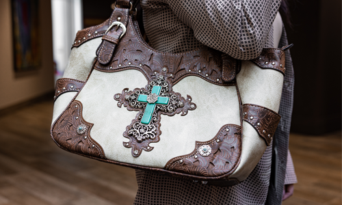 Brown leather bag being carried