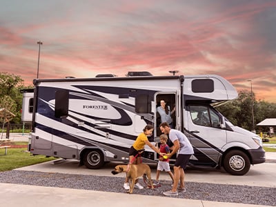 A photo of a family exiting an RV with their dog