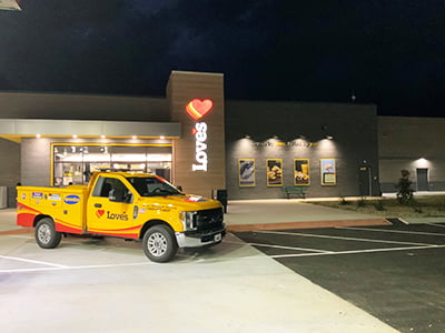 Loves truck stop exterior with truck care service truck parked outside in Madison, Georgia