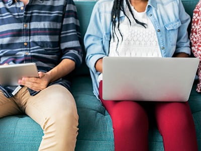 two people sitting working on laptops