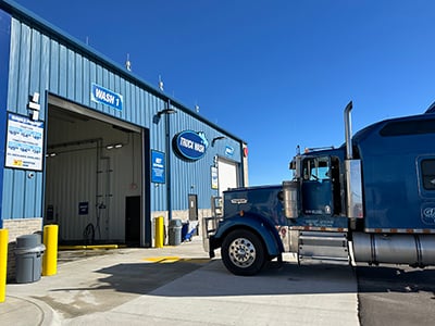 A truck pulled up to a Truck Wash bay at a Love's Travel Stop