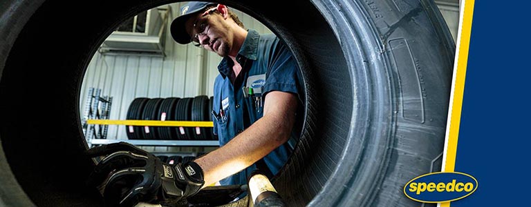 speedco crew member working on tire