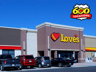 Front of a Love's Travel Stop building with cars parked in the front.