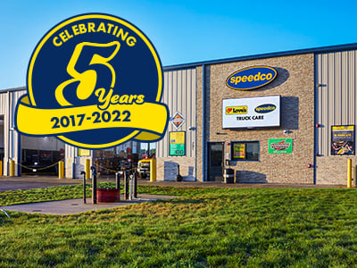 Front of a Speedco Truck Tire and Lube building with a 5 year anniversary symbol. 