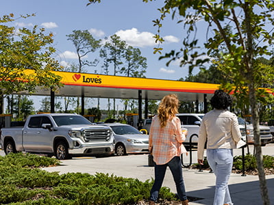 Two people walking in front of Love's Travel Stop