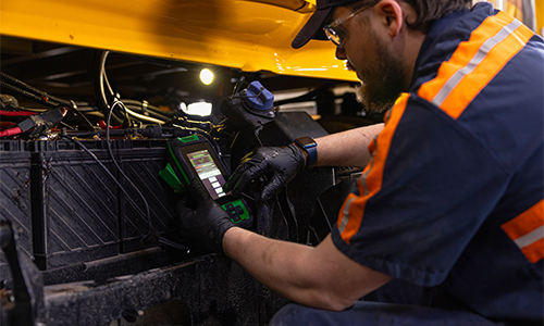 A Love's Truck Care technician working on an Interstate Battery