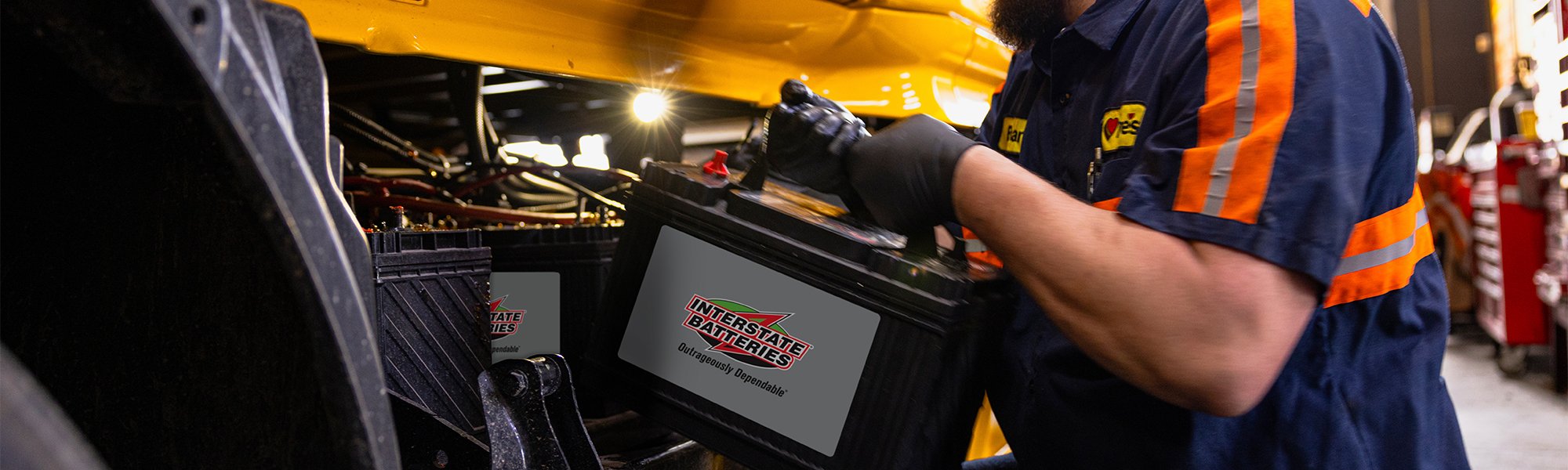 A Love's Truck Care technician working on an Interstate Battery