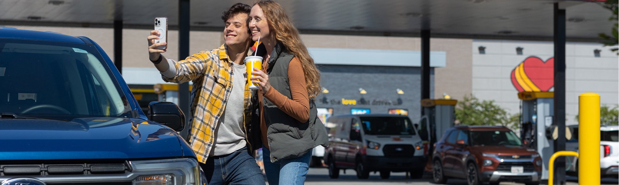 Love's Travel Stop customers taking a selfie in front of a Love's Travel Stop