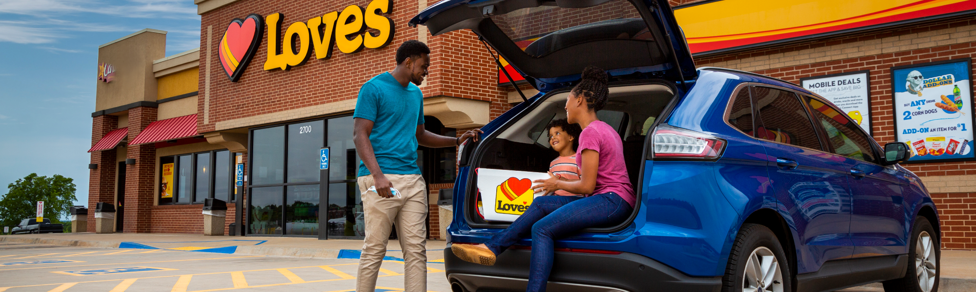 A family in their car outside a Love's