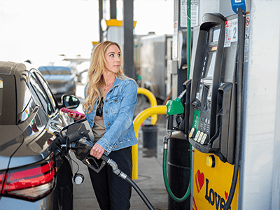 Woman pumping gas at a Love's Travel Stop