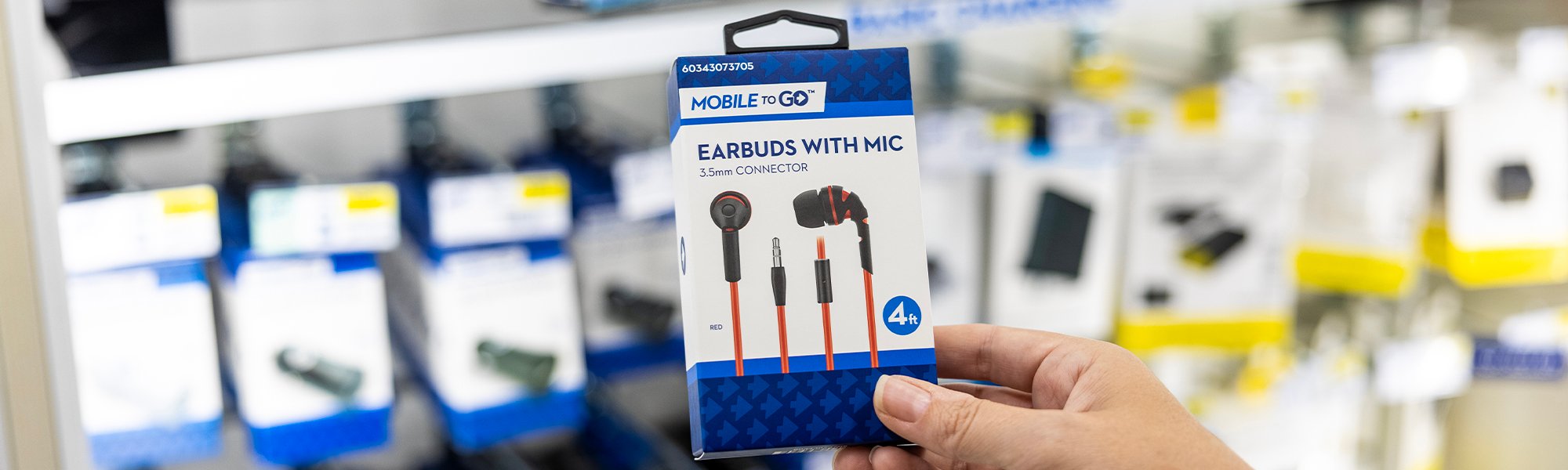 A customer holding Love's Mobile to Go earbuds
