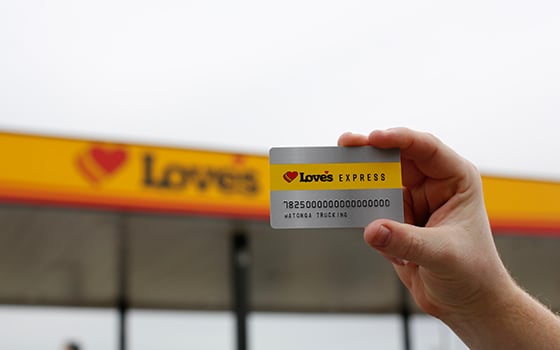 A hand holding a Love's Express credit card