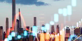 City skyline overlaid with financial charts and market data