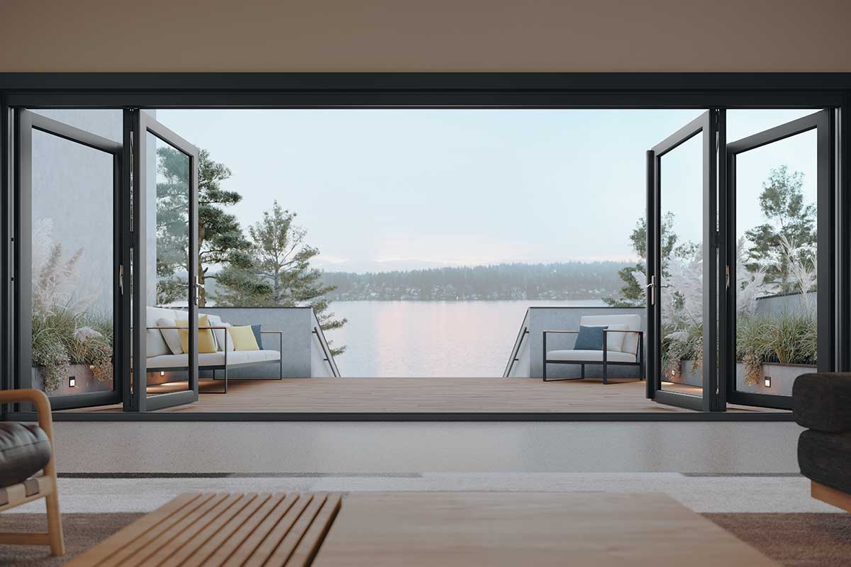 A living room with a Marvin Elevate Bi Fold Door overlooking a lake