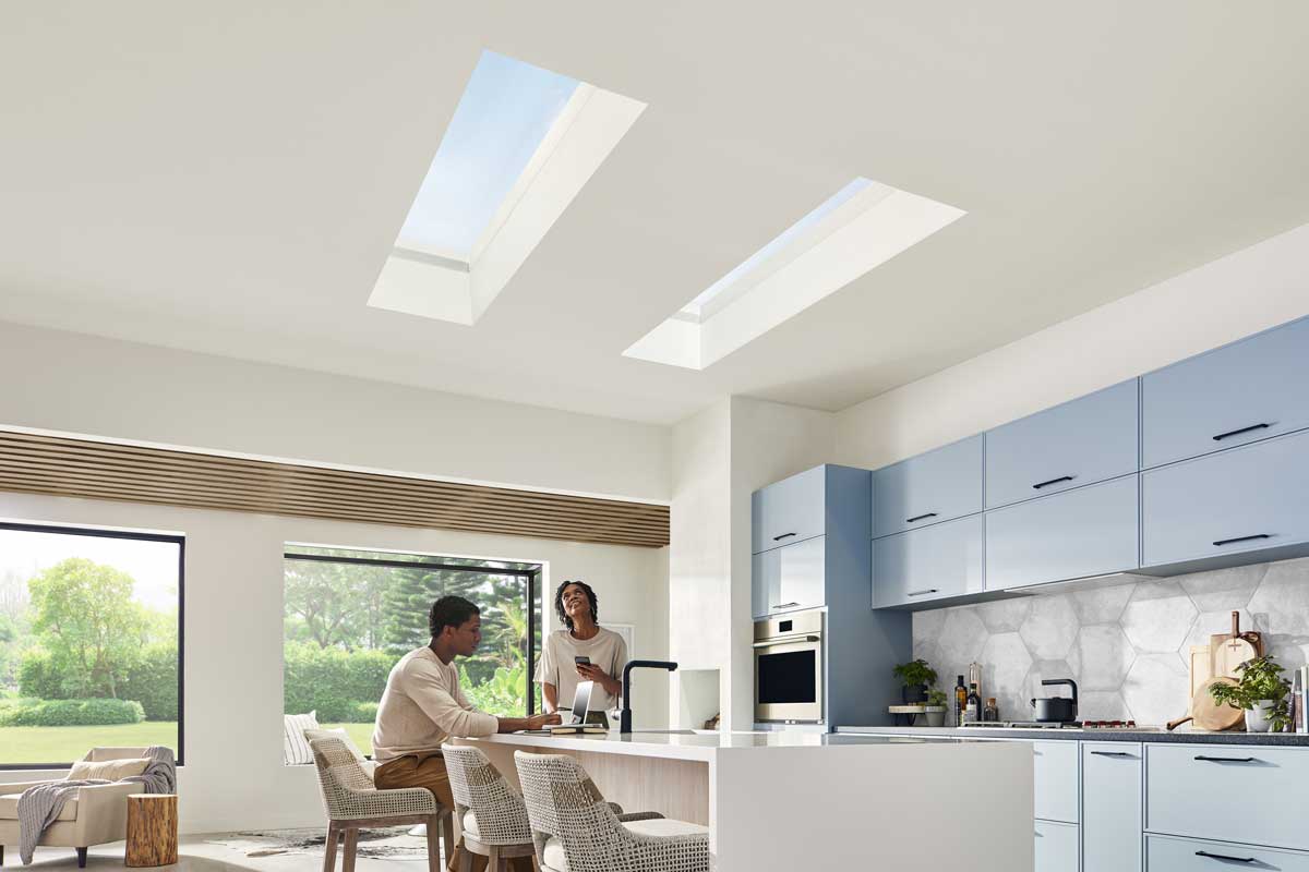 Two people in a kitchen with Awaken Skylights