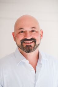 David Pizzimenti smiling headshot against a white background