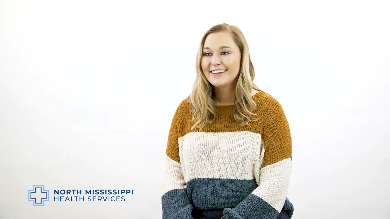 thumbnail of madison james introduction video with her sitting and smiling in a striped sweather with an NMHS logo in the bottom left of the screen