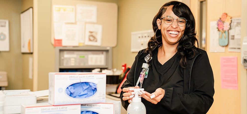 Health care working using hand sanitizer