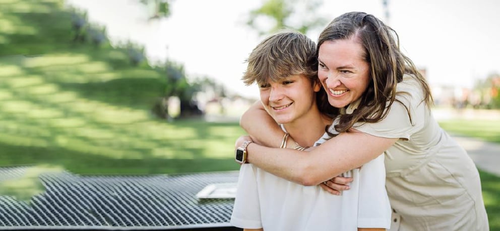 Mother hugging son
