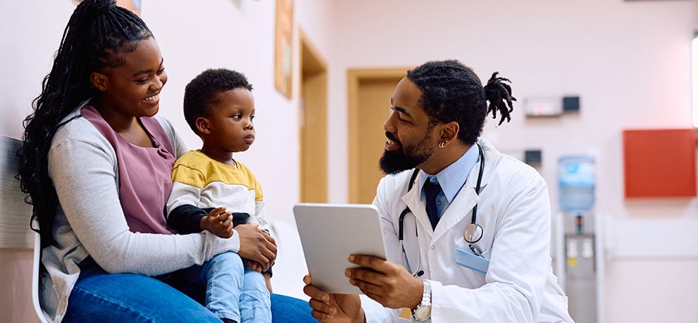 Doctor talking to a mother with a young child