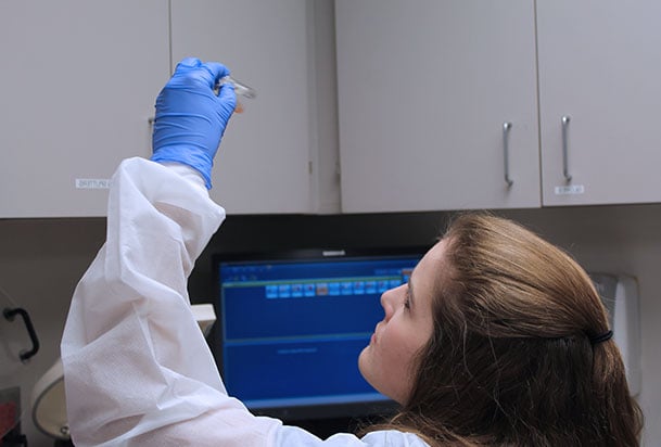 Med tech looking at samples