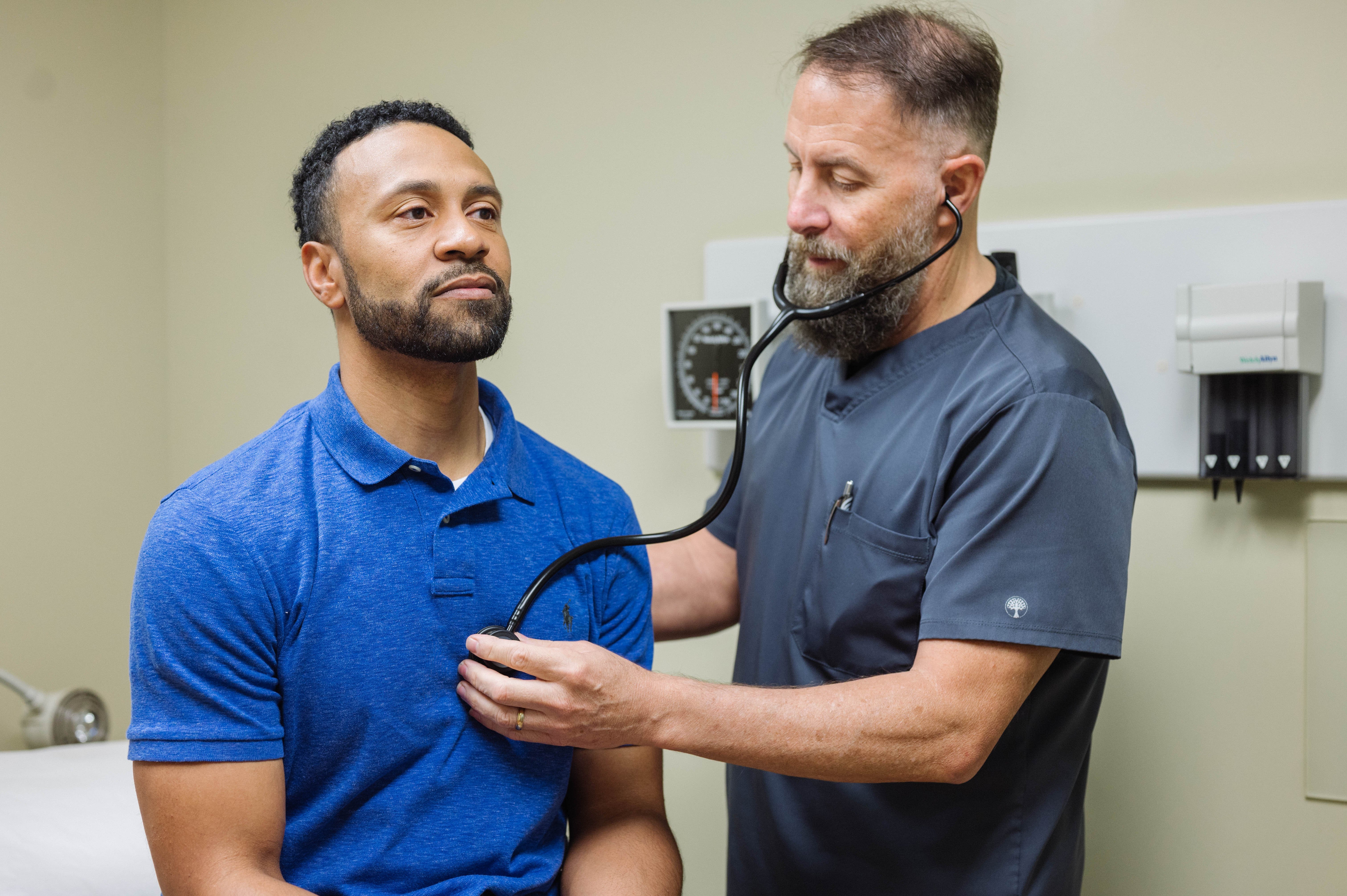 A doctor checks a patient's heart