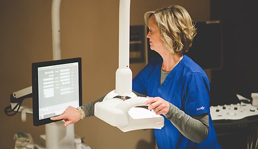 Technologist preps automated breast ultrasound