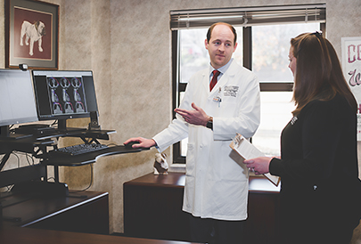 Doctor talking to patient while showing imaging results